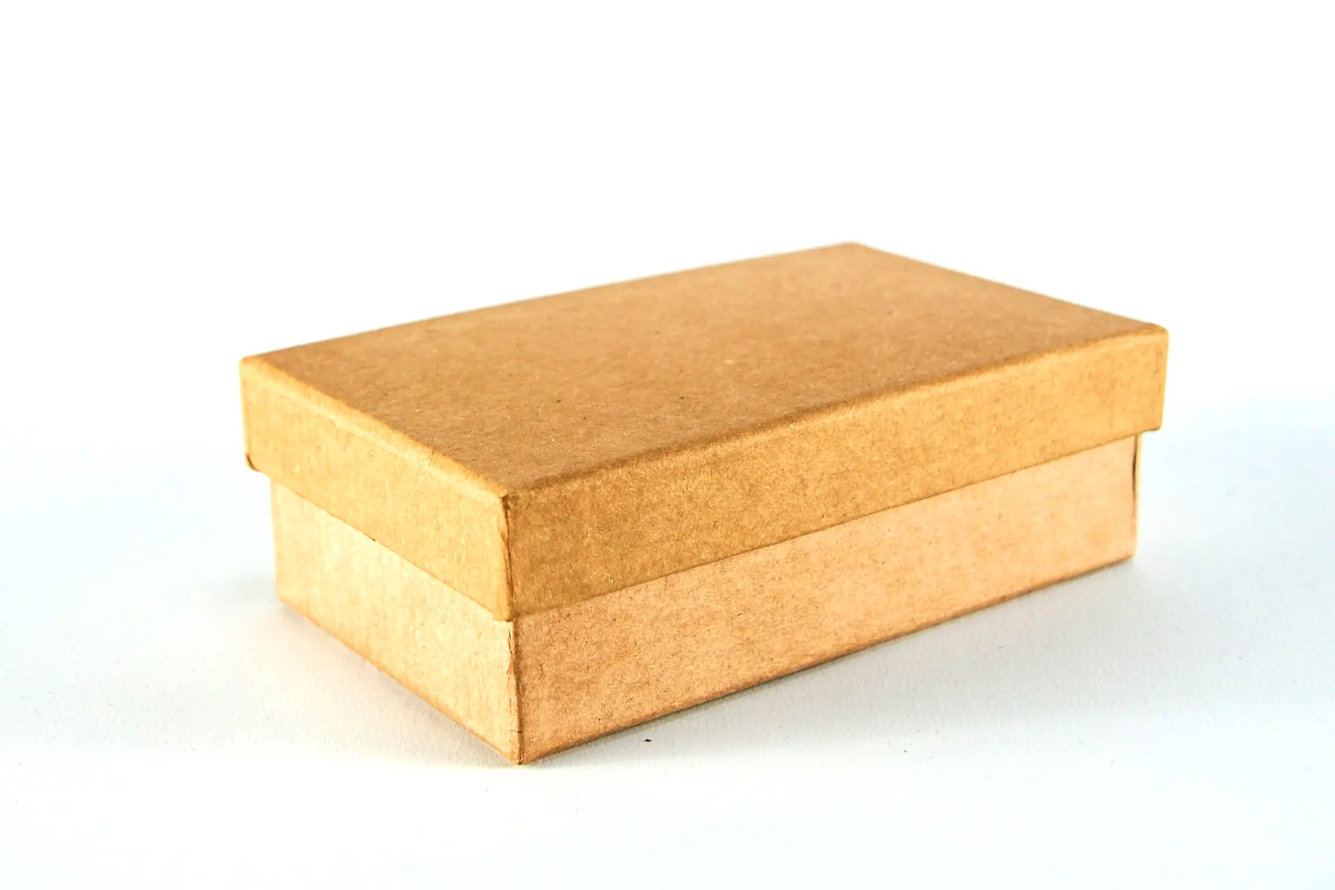 brown cardboard box on white surface